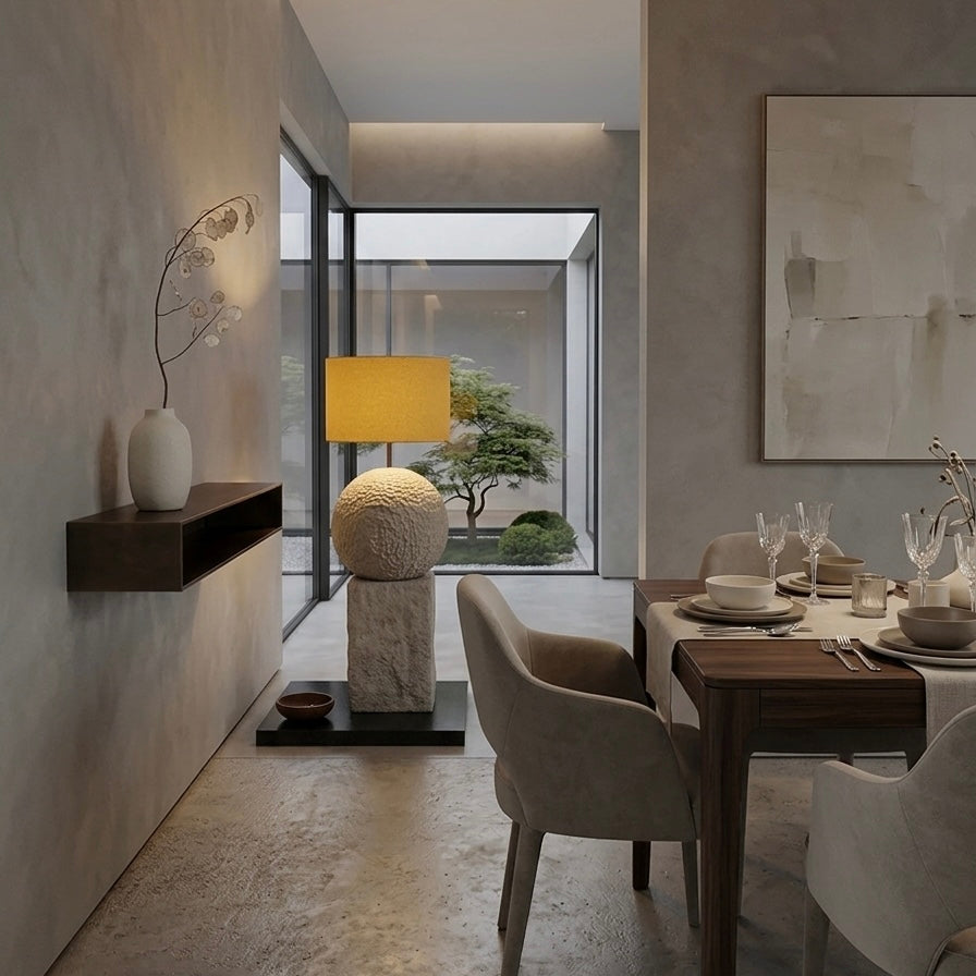Modern dining room with a table set for four, chairs, and decorative elements.
